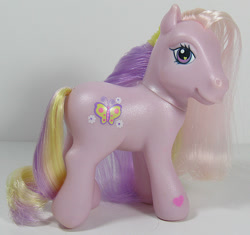 Size: 638x600 | Tagged: safe, imported from derpibooru, photographer:breyer600, fluttershy (g3), butterfly, earth pony, pony, cute, cutie mark, female, flower, g3, heart eyes, irl, looking at you, mare, photo, smiling, solo, toy, wingding eyes