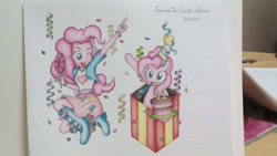 Size: 1536x864 | Tagged: safe, artist:fernandojc-draftsman, imported from derpibooru, pinkie pie, earth pony, pony, equestria girls, box, cake, clothes, confetti, duo, female, food, human ponidox, mare, one eye closed, party horn, pony in a box, present, self ponidox, signature, sitting, smiling, traditional art, wink