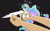 Size: 1280x800 | Tagged: safe, artist:gryphon bbq, artist:wirlog, imported from derpibooru, princess celestia, alicorn, human, pony, behaving like a bird, birb, black background, cute, cutelestia, female, holding a pony, in goliath's palm, looking at you, mare, micro, offscreen character, one wing out, open mouth, ponified animal photo, simple background, solo focus, sparkles, spread wings, tiny, tiny ponies, wing fluff, wings