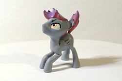 Size: 900x600 | Tagged: safe, artist:mraagh, imported from derpibooru, oc, oc only, oc:bordy, pegasus, pony, 3d, 3d print, 3d printed, eyebrows, eyes open, figurine, gray coat, looking up, male, multicolor hair, photo, shadow, simple background, solo, squatting, stallion, yellow eyes