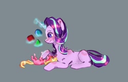 Size: 1030x664 | Tagged: safe, artist:lunar_cosmos, imported from derpibooru, luster dawn, starlight glimmer, pony, unicorn, blocks, cute, daaaaaaaaaaaw, female, filly, foal, glimmerbetes, glowing horn, gray background, horn, levitation, luster dawn is starlight's and sunburst's daughter, lusterbetes, lying down, magic, mama starlight, mother and child, mother and daughter, offspring, parent:starlight glimmer, parent:sunburst, parents:starburst, simple background, smiling, telekinesis