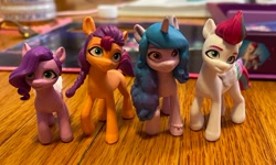 Size: 730x437 | Tagged: safe, imported from derpibooru, izzy moonbow, pipp petals, sunny starscout, zipp storm, earth pony, pegasus, pony, unicorn, figurine, g5, irl, my little pony: a new generation, photo, toy