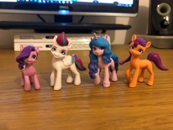 Size: 4032x3024 | Tagged: safe, imported from derpibooru, izzy moonbow, pipp petals, sunny starscout, zipp storm, earth pony, pegasus, pony, unicorn, figurine, g5, irl, my little pony: a new generation, photo, pipp is short, toy