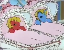 Size: 1963x1534 | Tagged: safe, imported from derpibooru, screencap, baby ribbon, baby shady, earth pony, pony, unicorn, 1980's, 1986, 80s, advertisement, awake, baby, baby buggy, baby pony, baby ribbondorable, baby shadybetes, beddy bye eye baby ponies, beddy bye eyes, blanket, commercial, cute, duo, female, filly, g1, looking at each other, lullabye nursery, smiling, smiling at each other, stroller, wake up