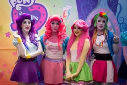 Size: 912x608 | Tagged: safe, imported from derpibooru, fluttershy, pinkie pie, rainbow dash, rarity, human, equestria girls, clothes, dancing, eqg el show en vivo, equestria girls logo, irl, irl human, legs, live action, photo