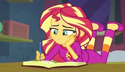 Size: 1250x720 | Tagged: safe, imported from derpibooru, screencap, sunset shimmer, equestria girls, book, clothes, female, happy, pajamas, smiling, solo, writing