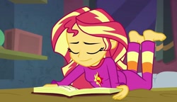 Size: 1253x720 | Tagged: safe, imported from derpibooru, screencap, sunset shimmer, equestria girls, equestria girls series, forgotten friendship, barefoot, book, clothes, eyes closed, feet, female, lying down, pajamas, smiling, solo