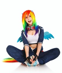 Size: 1080x1260 | Tagged: safe, artist:natsumipon, imported from derpibooru, rainbow dash, human, belly button, clothes, cosplay, costume, fingerless gloves, gloves, irl, irl human, open mouth, open smile, photo, shoes, simple background, sitting, smiling, sneakers, white background