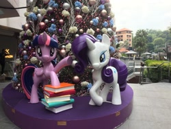 Size: 3264x2448 | Tagged: safe, imported from derpibooru, photographer:squeakybelle, rarity, twilight sparkle, alicorn, pony, unicorn, 2018, book, calvin klein, christmas, christmas tree, high res, holiday, irl, photo, singapore, statue, tree, twilight sparkle (alicorn)