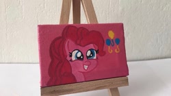 Size: 650x364 | Tagged: safe, alternate version, artist:lillycloudart, imported from derpibooru, pinkie pie, earth pony, pony, canvas, eyelashes, female, grin, irl, mare, photo, smiling, solo, toy, traditional art