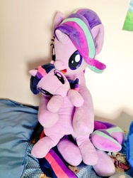 Size: 768x1024 | Tagged: safe, artist:nekokevin, imported from derpibooru, starlight glimmer, twilight sparkle, pony, unicorn, series:nekokevin's glimmy, bed, duo, female, irl, looking at you, mare, open mouth, photo, plushie, sitting, size difference, smiling, unicorn twilight