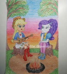Size: 1080x1196 | Tagged: safe, artist:mmy_little_drawings, imported from derpibooru, applejack, rarity, equestria girls, equestria girls series, sunset's backstage pass!, spoiler:eqg series (season 2), amputee, bedroom eyes, boots, campfire, clothes, eyelashes, female, guitar, high heel boots, high heels, lesbian, musical instrument, open mouth, outdoors, rarijack, shipping, shoes, shorts, sitting, smiling, stump, sunset, traditional art, tree, tree stump, watermark