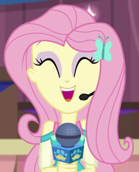 Size: 562x699 | Tagged: safe, imported from derpibooru, screencap, fluttershy, best in show: the victory lap, equestria girls, equestria girls series, spoiler:eqg series (season 2), ^^, cropped, cute, earpiece, eyes closed, eyeshadow, fluttershy boho dress, geode of fauna, giggling, jewelry, magical geodes, makeup, microphone, necklace, open mouth, open smile, pink eyeshadow, pink hair, shyabetes, sleeveless, smiling, solo, yellow skin
