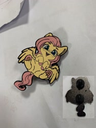 Size: 1536x2048 | Tagged: safe, artist:miokomata, imported from derpibooru, fluttershy, pegasus, pony, colored hooves, craft, cute, enamel pin, female, freckles, freckleshy, frog (hoof), irl, mare, photo, pin, shyabetes, solo, underhoof