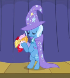 Size: 652x720 | Tagged: safe, imported from derpibooru, screencap, trixie, pony, unicorn, boast busters, season 1, bipedal, bouquet, brooch, cape, clothes, cropped, curtains, eyes closed, flower, hat, jewelry, smiling, solo, stage, stars, trixie's brooch, trixie's cape, trixie's hat