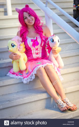 Size: 866x1390 | Tagged: safe, imported from derpibooru, fluttershy, pinkie pie, human, clothes, cosplay, costume, dress, irl, irl human, obtrusive watermark, photo, plushie, sandals, stock photo, watermark