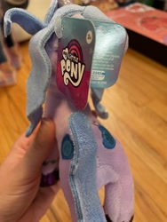 Size: 3024x4032 | Tagged: safe, imported from derpibooru, photographer:errant_harpy, izzy moonbow, pony, unicorn, both cutie marks, facing away, female, g5, irl, mare, my little pony logo, my little pony: a new generation, photo, plushie, toy