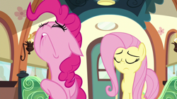 Size: 1280x720 | Tagged: safe, imported from derpibooru, screencap, fluttershy, pinkie pie, earth pony, pegasus, pony, buckball season, season 6, duo, duo female, eyes closed, faic, female, floppy ears, friendship express, lip bite, mare, struggling, train