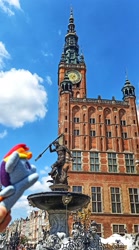 Size: 1135x2048 | Tagged: safe, imported from derpibooru, rainbow dash, pegasus, pony, fountain, gdansk, irl, neptune, photo, plushie, poland, ponies around the world, statue