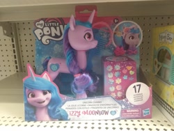 Size: 4160x3120 | Tagged: safe, imported from ponybooru, izzy moonbow, earth pony, unicorn, female, figure, g5, looking at you, my little pony logo, my little pony: a new generation, photo, toy, walmart