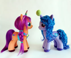 Size: 1000x810 | Tagged: safe, artist:larsen toys, artist:larsen_toys, imported from derpibooru, izzy moonbow, sunny starscout, earth pony, pony, unicorn, badge, bag, ball, duo, fake horn, female, g5, horn, hornball, izzy's tennis ball, mare, plushie, satchel, simple background, tennis ball, white background