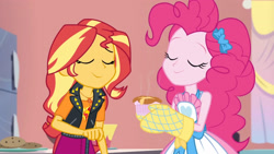 Size: 3410x1920 | Tagged: safe, imported from derpibooru, screencap, pinkie pie, sunset shimmer, equestria girls, equestria girls series, holidays unwrapped, spoiler:eqg series (season 2), apron, clothes, eyes closed, female, food, geode of empathy, jacket, jewelry, leather, leather jacket, magical geodes, necklace, oven mitts, ramekin, saving pinkie's pie, smiling, souffle, tanktop