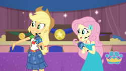 Size: 3410x1920 | Tagged: safe, imported from derpibooru, screencap, applejack, fluttershy, best in show: the victory lap, equestria girls, equestria girls series, spoiler:eqg series (season 2), applejack's hat, belt, best in show logo, clothes, cowboy hat, cutie mark, cutie mark on clothes, denim skirt, female, geode of fauna, geode of super strength, hairpin, hand on hip, hat, jewelry, magical geodes, microphone, necklace, open mouth, skirt, smiling