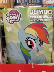 Size: 3120x4160 | Tagged: safe, imported from derpibooru, rainbow dash, pegasus, pony, coloring book, dollar tree, female, high res, irl, mare, my little pony jumbo coloring book, my little pony logo, open mouth, open smile, photo, raised hoof, smiling, solo, spread wings, wings