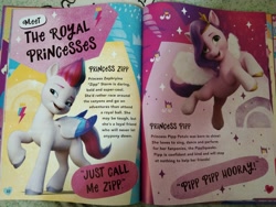 Size: 4160x3120 | Tagged: safe, imported from derpibooru, pipp petals, zipp storm, pegasus, pony, book, g5, irl, my little pony annual 2022, my little pony: a new generation, photo, pipp pipp hooray