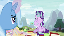 Size: 1334x750 | Tagged: safe, imported from derpibooru, screencap, starlight glimmer, trixie, pony, unicorn, student counsel, cup, cupcake, duo, duo female, eating, eyes closed, female, food, glowing, glowing horn, herbivore, horn, magic, mare, picnic blanket, ponyville, sandwich, teacup, teapot, telekinesis