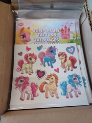 Size: 3000x4000 | Tagged: safe, imported from derpibooru, izzy moonbow, pinkie pie, pony, unicorn, box, castle, dollar tree, female, g5, heart, irl, male, not izzy moonbow, not pinkie pie, photo, tattoo
