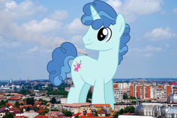 Size: 2048x1371 | Tagged: safe, artist:dashiesparkle, artist:jaredking779, imported from derpibooru, party favor, pony, unicorn, giant pony, giant unicorn, highrise ponies, irl, looking back, macro, male, mega giant, oradea, photo, ponies in real life, romania, smiling, solo, stallion