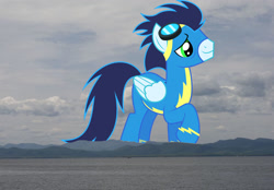 Size: 1024x713 | Tagged: safe, artist:dashiesparkle, artist:jaredking779, imported from derpibooru, soarin', pegasus, pony, burlington, clothes, giant pegasus, giant pony, goggles, highrise ponies, irl, macro, male, mega giant, mountain, mountain range, photo, ponies in real life, smiling, stallion, uniform, vermont, wonderbolts uniform