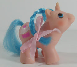 Size: 688x600 | Tagged: safe, imported from derpibooru, pony, unicorn, baby, baby pony, bow, braid, brushable, g1, irl, li'l cupcake, photo, ribbon, smiling, toy