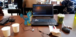 Size: 1776x864 | Tagged: safe, imported from derpibooru, photographer:horsesplease, gallus, augmented reality, birb, computer, dice, earbuds, gameloft, laptop computer, malaysia, micro, solo, starbucks