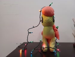 Size: 4000x3000 | Tagged: safe, artist:topsangtheman, imported from derpibooru, peachy sweet, earth pony, pony, apple family member, christmas, christmas lights, holiday, irl, looking at you, photo, plushie, solo