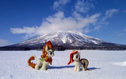 Size: 2048x1293 | Tagged: safe, imported from derpibooru, photographer:pakapaka1993, autumn blaze, oc, oc:poniko, earth pony, kirin, pony, cloud, duo, earth pony oc, irl, japan, mountain, photo, plushie, snow, winter