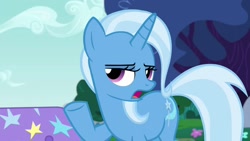 Size: 1280x720 | Tagged: safe, imported from derpibooru, screencap, trixie, pony, unicorn, no second prances, season 6, female, horn, lidded eyes, mare, open mouth, outdoors, raised hoof, solo, tail