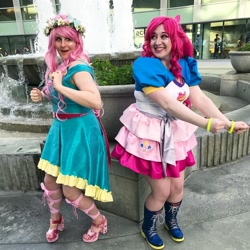 Size: 1080x1080 | Tagged: safe, artist:sweetalissum, imported from derpibooru, kotobukiya, fluttershy, pinkie pie, human, clothes, cosplay, costume, floral head wreath, flower, fountain, irl, irl human, kotobukiya pinkie pie, photo, wondercon