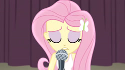 Size: 3410x1920 | Tagged: safe, imported from derpibooru, screencap, fluttershy, human, acadeca, equestria girls, friendship games, bare shoulders, clothes, eyes closed, female, hairpin, high res, microphone, sleeveless, solo, tanktop