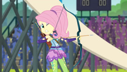 Size: 3410x1920 | Tagged: safe, imported from derpibooru, screencap, fluttershy, equestria girls, friendship games, archery, female, high res, one eye closed, sleeveless, solo