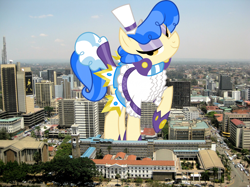 Size: 2048x1534 | Tagged: safe, artist:dashiesparkle, artist:thegiantponyfan, imported from derpibooru, sapphire shores, earth pony, pony, female, giant pony, giant sapphire shores, giant/macro earth pony, giantess, highrise ponies, irl, kenya, looking at you, macro, mare, mega giant, nairobi, photo, ponies in real life, raised hoof, smiling, solo