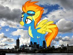 Size: 800x600 | Tagged: safe, artist:issyrael, artist:thegiantponyfan, imported from derpibooru, spitfire, pegasus, pony, clothes, england, female, giant pegasus, giant pony, giant/macro spitfire, giantess, goggles, highrise ponies, irl, london, macro, mare, mega giant, photo, ponies in real life, smiling, spread wings, uniform, united kingdom, wings, wonderbolts uniform