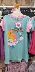 Size: 2752x5664 | Tagged: safe, imported from derpibooru, fluttershy, rainbow dash, pegasus, pony, clothes, duo, female, irl, mare, merchandise, my little pony logo, open mouth, open smile, shirt, smiling, spread wings, t-shirt, text, wings