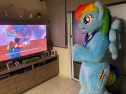 Size: 680x510 | Tagged: safe, artist:atalonthedeer, imported from derpibooru, rainbow dash, anthro, pegasus, pony, controller, dead space, female, fursuit, gaming, irl, photo, ponysuit, standing, television, wings