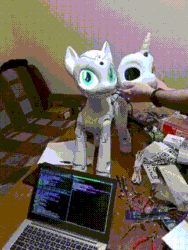 Size: 324x432 | Tagged: safe, imported from derpibooru, sweetie belle, human, pony, robot, robot pony, animated, computer, gif, irl, laptop computer, looking at you, photo, proto3, sweetie bot, sweetie bot project, table, technology