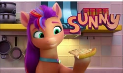 Size: 1080x638 | Tagged: safe, imported from derpibooru, screencap, sunny starscout, earth pony, pony, spoiler:my little pony: make your mark, food, g5, kitchen, mane stripe sunny, my little pony: make your mark, my little pony: make your mark chapter 1, pizza, solo, text