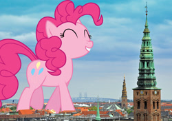 Size: 2047x1445 | Tagged: safe, artist:stjonal, artist:thegiantponyfan, imported from derpibooru, pinkie pie, earth pony, pony, copenhagen, denmark, eyes closed, female, giant pinkie pie, giant pony, giant/macro earth pony, giantess, grin, highrise ponies, irl, macro, mare, mega giant, photo, ponies in real life, smiling, solo