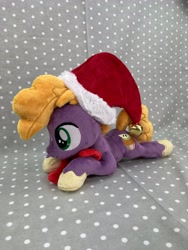 Size: 3024x4032 | Tagged: safe, artist:kazzysart, imported from derpibooru, little mac, pony, christmas, hat, holiday, irl, lying down, photo, plushie, prone, santa hat, solo