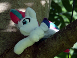 Size: 1307x980 | Tagged: safe, artist:bastler, imported from derpibooru, zipp storm, pegasus, pony, colored wings, female, g5, irl, mare, multicolored wings, my little pony: a new generation, photo, plushie, solo, tree, tree branch, wings